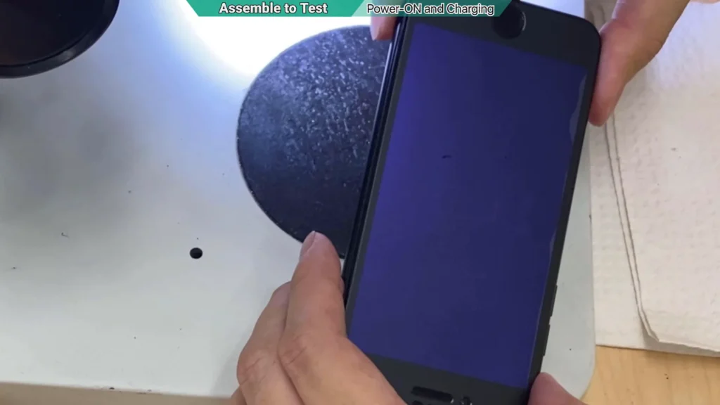Repaired iPhone displaying the charging screen after connecting a USB cable following motherboard repair.