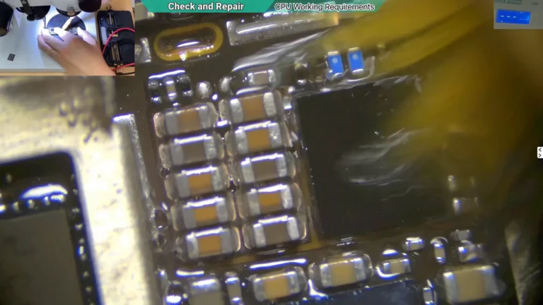 Microscope image showing the CPU startup circuit cleaning corrosion with PCB cleaner and a soft brush.