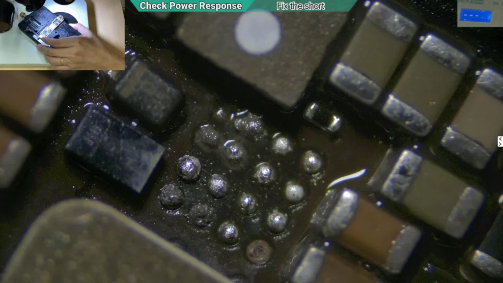 Microscope image showing the cleaned backlight circuit after corrosion removal on a water-damaged iPhone motherboard.