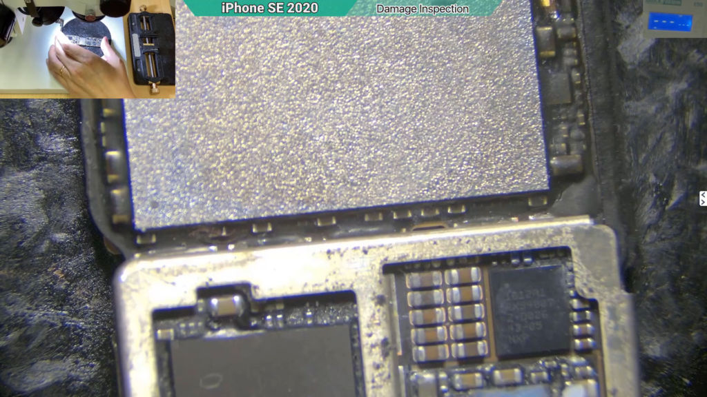 Microscope view of corrosion on the USB circuit of a water-damaged iPhone motherboard.