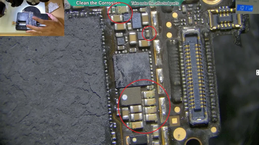 Microscope view showing an iPhone motherboard after the protective shield was removed, with a microscope close-up revealing hidden corrosion beneath the shield.