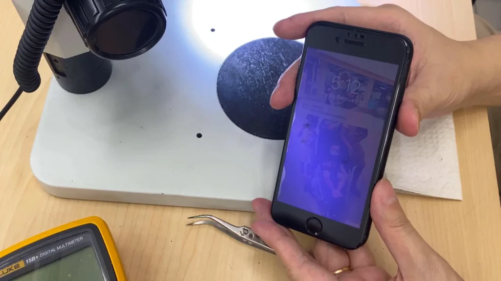 Repaired iPhone successfully booting to the original lock screen with the customer's data preserved after motherboard repair.