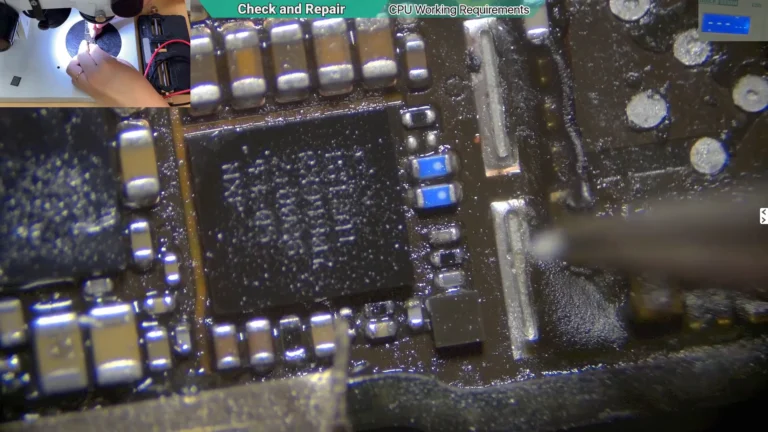 Microscope image showing the USB IC area after removing the protective shield from a water-damaged iPhone motherboard