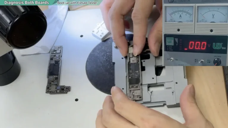 Technician positioning the separated iPhone 13 motherboard into a sandwich board testing fixture for diagnosis.