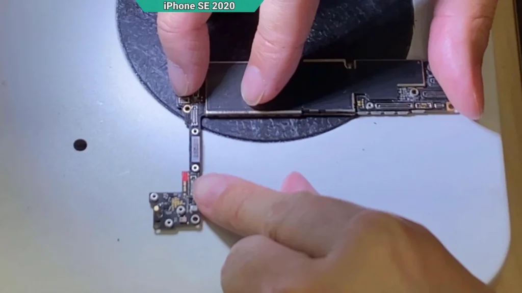 Liquid Contact Indicator (LCI) on an iPhone motherboard changed from white to red, confirming the device has been exposed to liquid.