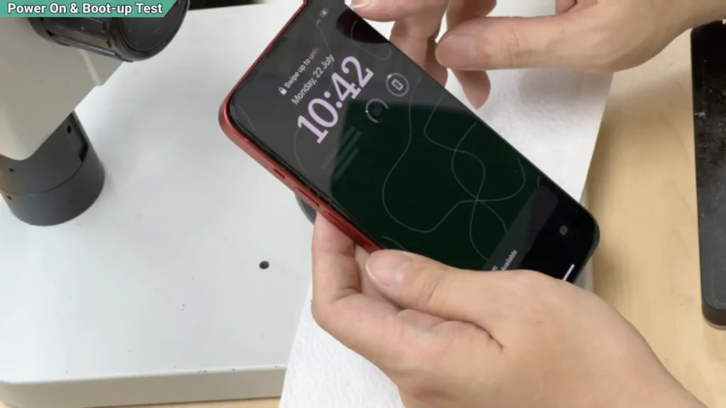 iPhone 13 successfully powered on after motherboard repair and sandwich board reball.