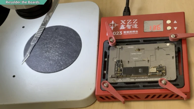 iPhone 13 sandwich motherboard secured on a preheater before reassembling the two board layers.