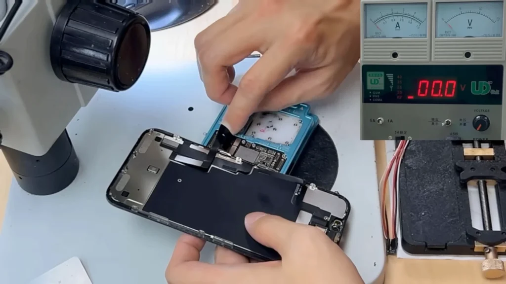 iPhone 11 repaired logic board connected to screen for boot testing