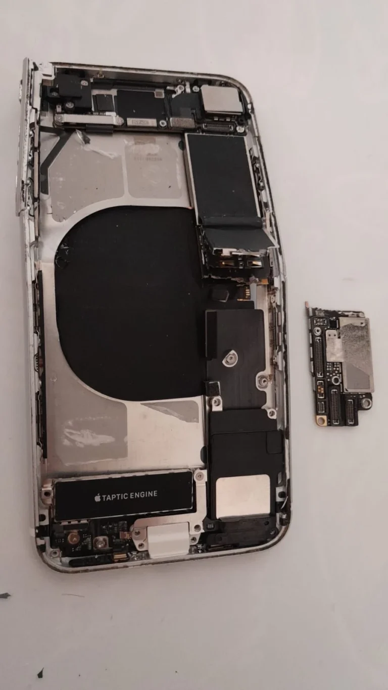 Damaged iPhone with screen and battery removed, exposing the logic board inside the bent housing