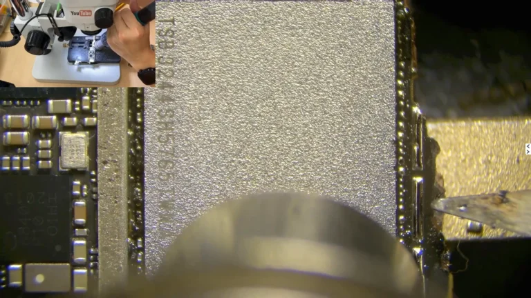 Original NAND flash memory being removed from the severely damaged iPhone motherboard