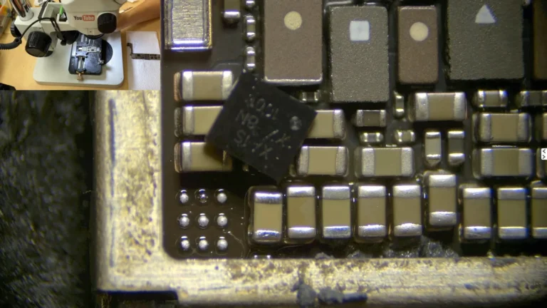 Original iPhone logic EEPROM being removed from the damaged motherboard for data recovery