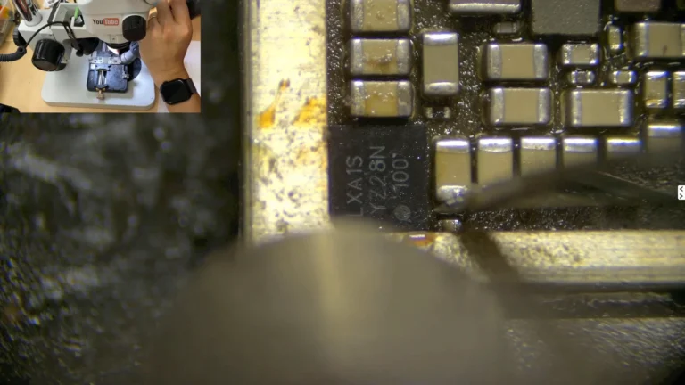 Original iPhone logic EEPROM being installed onto the donor motherboard with hot air