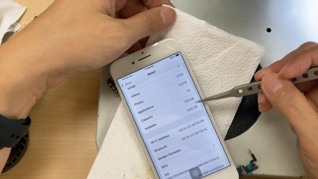 iPhone Settings showing 128 GB storage after successful data recovery from the severely damaged motherboard